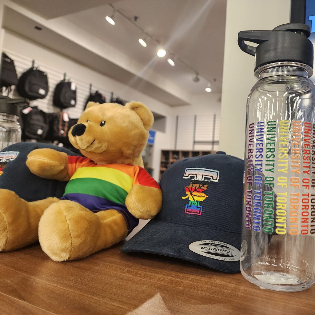 Display Your Pride merchandise: caps, teddy bear and water bottles
